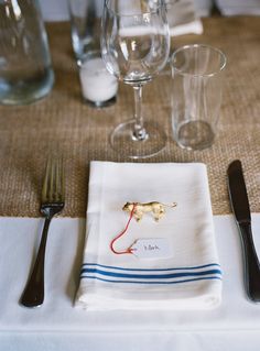 a place setting with utensils and wine glasses