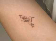 a small hummingbird tattoo on the thigh