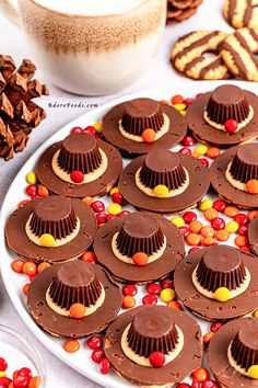 there are many desserts on the plate and one is decorated with chocolate, candy, and candies