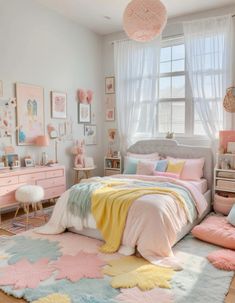 a bedroom decorated in pastel colors with pink, blue and yellow accents on the bed