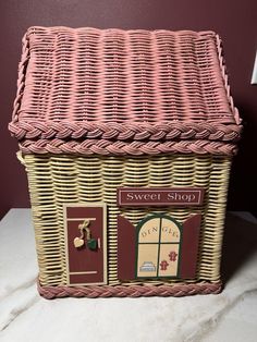 a wicker basket with the words sweet shop painted on it's front door