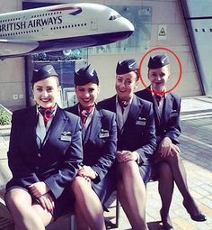 four cabin attendants sitting on a bench in front of an airplane