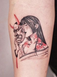 a woman with a demon mask on her arm