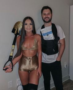 a man standing next to a woman in a gold bathing suit