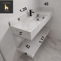 a bathroom with two sinks and numbers on the wall above them in black and white