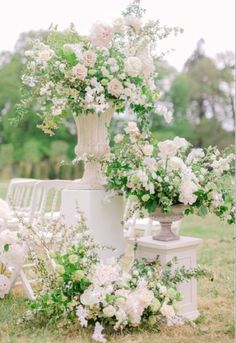 an arrangement of flowers and chairs in the grass