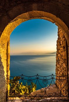 an open window looking out at the ocean