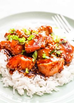 a white plate topped with rice and meat