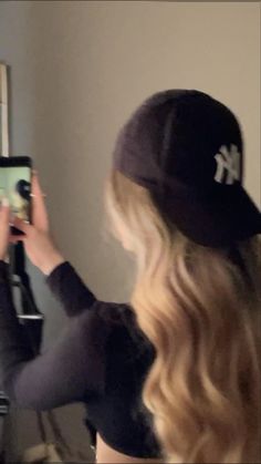 a woman is taking a selfie in front of a mirror with her cell phone