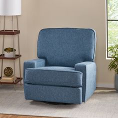 a living room with a blue recliner and potted plants on the side table