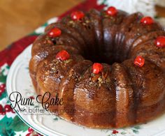 a bundt cake with cherries on it sitting on a plate