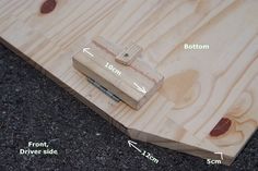 a piece of wood that is laying on the ground with measurements to be taken out