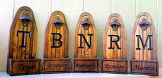 four wooden signs with the letters rrm, mr and mrs on them are lined up against a white wall