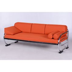 an orange couch sitting on top of a metal frame