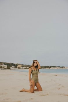 The flirty and feminine top you've been waiting for is finally here. This soft green swimsuit is the perfect shade for countless skin tones, and the golden-yellow wildflower print has us begging for the warmer days ahead. The two-sided ruffled straps can be worn on or off the shoulders- giving you the freedom to mix it up to match your mood. This modest tankini top is mid length, offering great coverage for your tummy and back to keep you comfortable for any activity. The model pairs the Bella T Modest Tankini, Wildflower Print, Modest Top, Yellow Wildflowers, Modest Swimsuits, Feminine Top, Green Swimsuit, Swim Skirt, Swim Bottoms