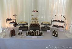 a table topped with lots of cakes and desserts