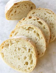 several pieces of bread sitting on top of a white countertop next to each other