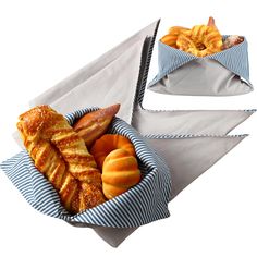 there are many different types of pastries in the basket on this white tablecloth