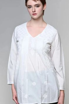 The "Divya" Embroidered Tunic Top from Sevya is handmade of 100% cotton and features a comfortable, elegant cut. This V-neck three quarter sleeve embroidered tunic top features beautiful "Chikankari" floral embroidery on the front and back. Chikankari is a delicate and artfully done hand embroidery that women in Northern India have been doing for generations. Size M fits 8-10, L 12-14, XL 16-18. This embroidered tunic top is ethically and sustainably fair trade. Made in India. Machine Washable. Mermaid Candles, White Floral Embroidery, White Tunic Tops, Bath And Body Shop, Embroidered Tunic Top, White Tunic, Yoga Accessories, Caftan Dress, Embroidered Tunic