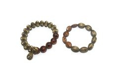 This item is a pair of vintage gold tone and brown beads elastic beaded bracelets. These bracelets are 7 1/2 inches. Wear together, alone, or stacked with other bracelets for a different look.   DETAILS: ☼ Approximately 7 1/2 inches. ☼ Approximately 38.6 grams, total weight. ☼ ☼ ☼ ☼ ☼ ☼ ☼ ☼ ☼ ☼ ☼ ☼ ☼ ☼ ☼ ☼ ☼ ☼ ☼ ☼ ☼ PLEASE NOTE:  ☼ Different items on SALE everyday!  Check back often to take advantage of these bargains! ☼ FREE DOMESTIC SHIPPING on purchases of $35 or more. Combined shipping is st Bohemian Gold Stretch Bracelet With Wooden Beads, Vintage Gold Stretch Bracelet With Round Beads, Vintage Gold Beaded Stretch Bracelet, Elastic Beaded Bracelets, Favorite Pins, Vintage Gold, Porter, Vintage Jewelry, Jewelry Bracelets