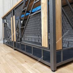 a metal and wood bunk bed with blue sheets