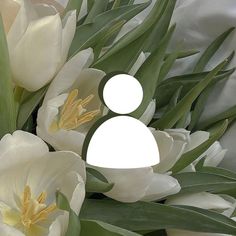 a bouquet of white flowers with a man in the center surrounded by green leaves and stems