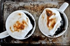 two mugs filled with hot chocolate and whipped cream