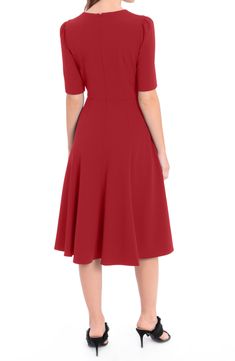 A figure flattering fit and flare silhouette makes this elbow sleeve dress a must-have addition to your wardrobe, finished off with a sleek V-neckline. 43" length (size 2) V-neck Elbow length sleeves Hidden back zip closure 96% polyester, 4% spandex Machine wash Imported Model stats: 5'10" height, 32" bust, 25" waist, 36" hip. Model is wearing size S. Formal A-line V-neck Fit And Flare Dress, Evening Dress With Half Sleeves, Fit And Flare V-neck Dress With Back Zipper, Solid Color Half Sleeve Evening Dress, Solid Color A-line V-neck Dress For Evening, A-line V-neck Dress For Evening, Solid Color Half Sleeve Formal Dress, Elegant A-line Midi Dress With Seams, Elegant Seamed A-line Midi Dress