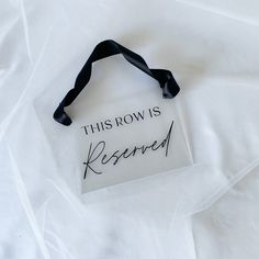 this row is reserved sign with black ribbon on white sheeted paper, top view