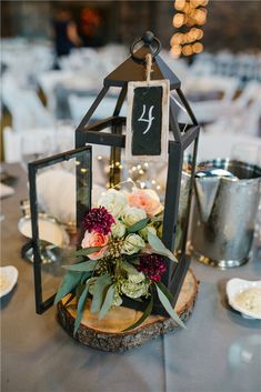 the table is set with flowers, candles and silverware for an elegant wedding reception