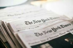 newspapers stacked on top of each other with the word new york times printed on them