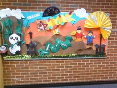 a bulletin board is decorated with paper cutouts and pandas in the background,