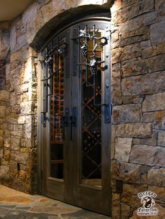 an image of a wine rack in the middle of a room with stone walls and doors