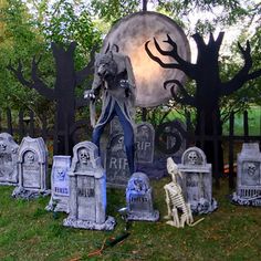 an outdoor cemetery with tombstones and skeletons in the foreground, surrounded by trees