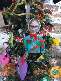 a child's christmas tree has been decorated with pictures