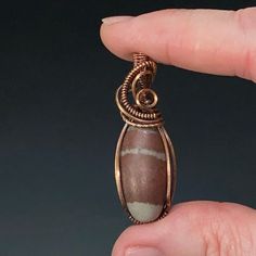 Shiva Lingam stone wire wrapped pendant with oxidized patina copper wire. Please note that this wire may tarnish and will need cleaning from time to time. Polish as needed with included polishing cloth.All pendants come in a jewelry gift box with a black waxed cord and small polishing cloth.Size: 43 x 13 x 12 mm. 10 grams. this stone is from India Lingam Shiva, Patina Copper, Shiva Lingam, Wire Wrap Pendant, Oxidized Copper, Copper Patina, Wrapped Pendant, Wire Wrap