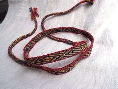 I'd like to present a woolen tablet woven headband which will make a great addition to a viking or medieval costume. The pattern is based on the tablet woven find from pre-Viking Norway - Vestrum. Very similar pattern was also found on a band from Viking Staraya Ladoga (10th c.)  This headband will also be perfect for LARP or as a hatband. The woven part takes about 50 cm / 19.5", the braided ends are about 30 cm long each. The headband is 1,3 cm wide /0,5", and made from wool. Please note that Slavic Clothing, Medieval Reenactment, Woven Headband, Card Weaving, Tablet Weaving, Medieval Costume, Braids With Weave, Costume Hats, Hat Band