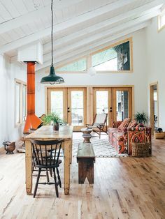 a living room filled with furniture and a fire place in the middle of a room