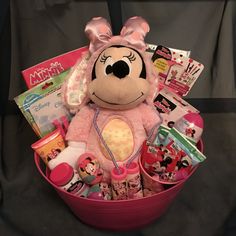 a pink basket filled with lots of toys and stuff to make it look like minnie mouse