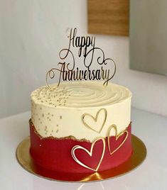 a white and red cake sitting on top of a table