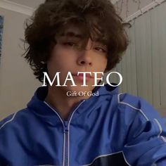 a young man wearing a blue jacket with the word mateo on it in front of him