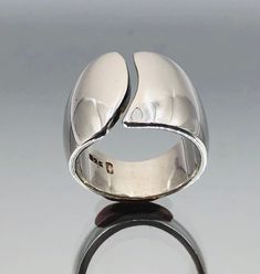 *About me: 925 silver split band ring. I'm a good chunky shiny split band ring. If you go for the modernist look wear me with other silver chunky rings on each finger and several chunky bracelets on both wrists, the more you wear the bigger your image statement! *Size: Approx. UK  K.5 to M, USA 6 to 6.75, EU 50 to 54, has a small amount of flex. Width approx. 1.5cm / 0.59 inches at front, 0.7cm / 0.27 inches at back *Weight: Approx. 11 grams *Hallmark: 925 *Age: Vintage *Condition: Good vintage Modern Hallmarked Open Band Rings, Modern Open Band 925 Stamped Rings, Modern Wide Band Ring With Polished Open Band, Bracelets On Both Wrists, Silver Dome Ring With Open Band Modern Style, Modern Silver Dome Ring With Open Band, Silver Chunky Rings, Brutalist Style Open Metal Ring, Brutalist Hand Cast Open Ring