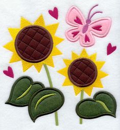 three sunflowers with hearts and a butterfly in the center on a white towel