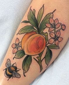 a peach and bees tattoo on the leg