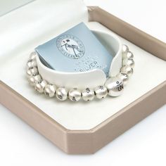 "All matte silver balls are carefully engraved with the three letters of the Tibetan Om Ah Hum. Each engraved letter is designed in a beautiful font in HEENAL. I am proud of the luxurious quality. This bracelet is perfect for wearing alone or layered with others.  It is made of high quality 8mm silver balls and one 12mm silver ball guru bead.  Made with elastic stretch transparent cord for a perfect fit so please select size from the drop-down menu. 13.5 cm (5.3 inch)   (12mm:1 / 8mm:20) 14.3 cm Luxury Sterling Silver Spiritual Bracelet, Luxury Spiritual Silver Beaded Bracelets, Luxury Sterling Silver Round Bead Bracelets, Luxury Sterling Silver Beaded Bracelets, Luxury Silver Bracelets With Polished Beads, Luxury Silver Beads Bracelets As Gift, Luxury Silver Beads Bracelets For Gift, Luxury Silver Beads Bracelet For Gift, Luxury Sterling Silver Beaded Bracelets For Gifts