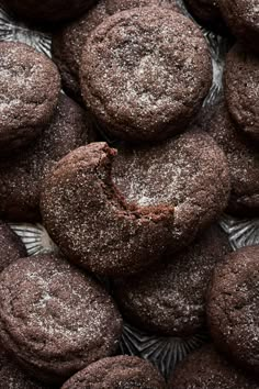 a pile of chocolate cookies covered in powdered sugar