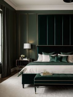 a bed with green velvet headboard and footstools in a dark room next to a window