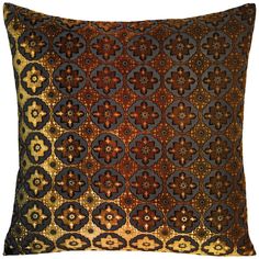 a brown and black pillow with an intricate design on the front, along with a gold border