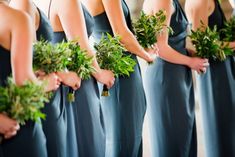 the bridesmaids are wearing blue dresses with greenery on them