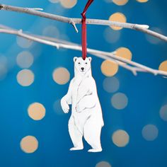 a polar bear ornament hanging from a twig